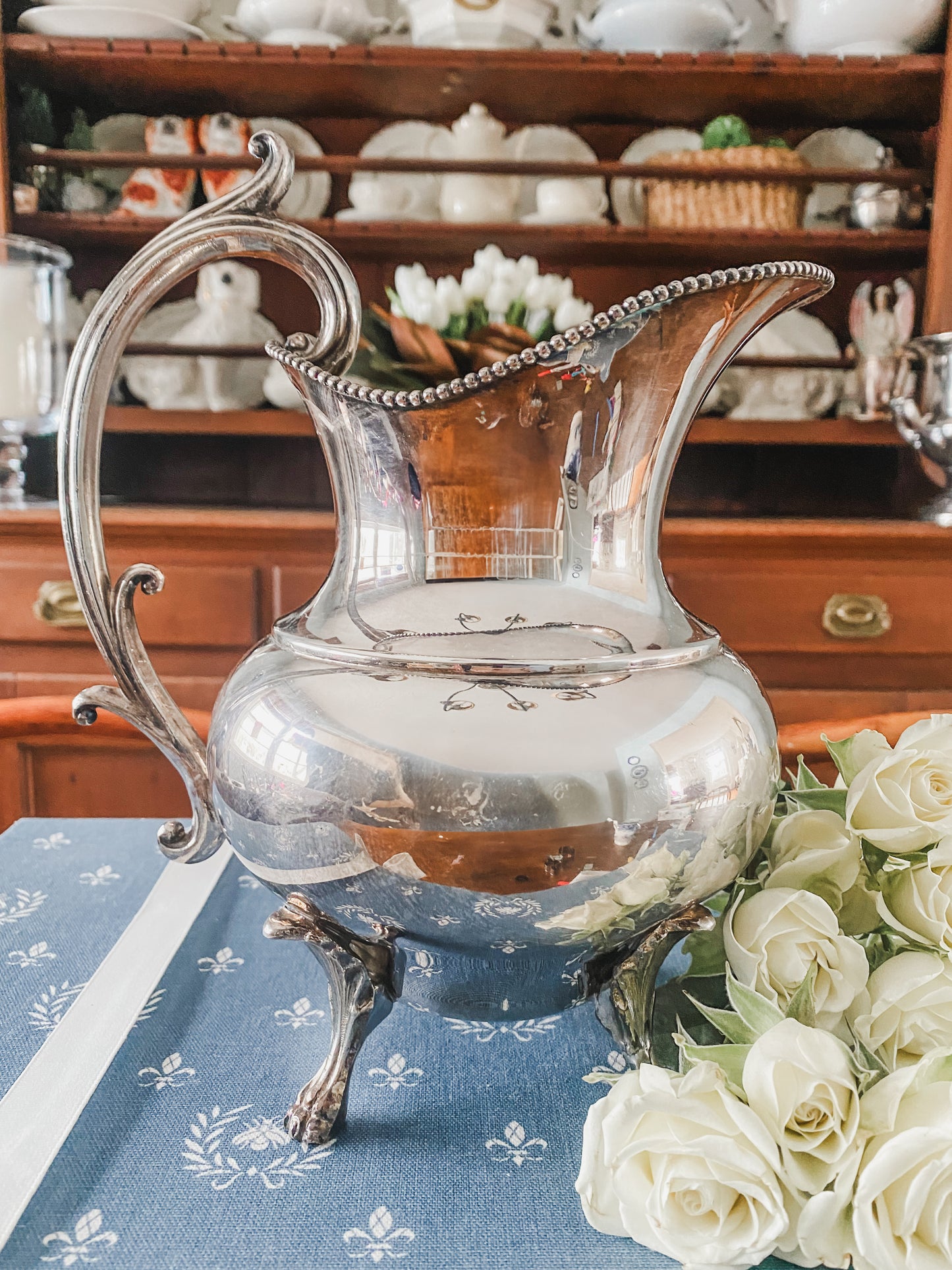 Early 1900s Silver-Plated Pitcher with Regal Lion’s Claw Feet & Ornate Handle